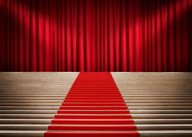 istock Staircase with red carpet and curtain with spotlights 476494314