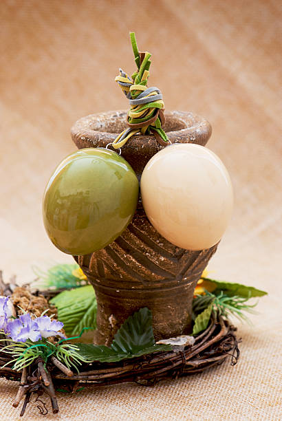 istock Two shiny easter eggs with ceramic vase and ornamental wicker 476494415