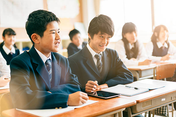 Japanese School Boys Using digital Tablet in Classroom Japanese Junior High School Students working together with digital tablet in classroom. child japanese culture japan asian ethnicity stock pictures, royalty-free photos & images