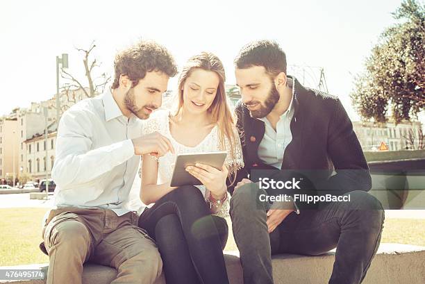 Three Friends Using Tablet Outdoor Stock Photo - Download Image Now - 20-24 Years, 20-29 Years, 2015