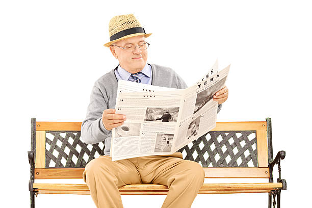 istock Senior gentleman reading newspaper on a bench 476495877