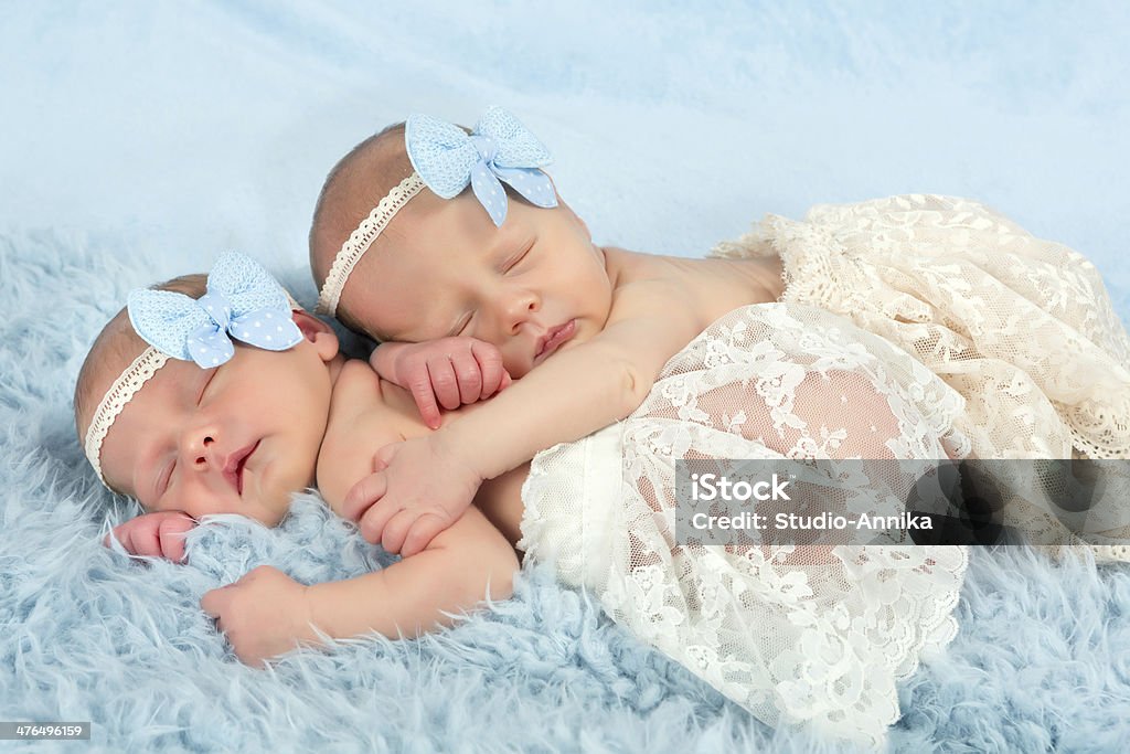 Newborn twin girls Two adorable newborn twin babies asleep on a soft blanket Baby - Human Age Stock Photo