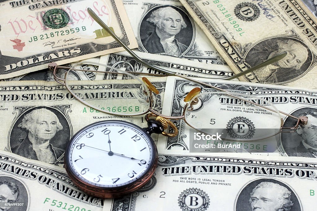 dollar watch shows old spectacles, dollars and watch as element of the business Antique Stock Photo