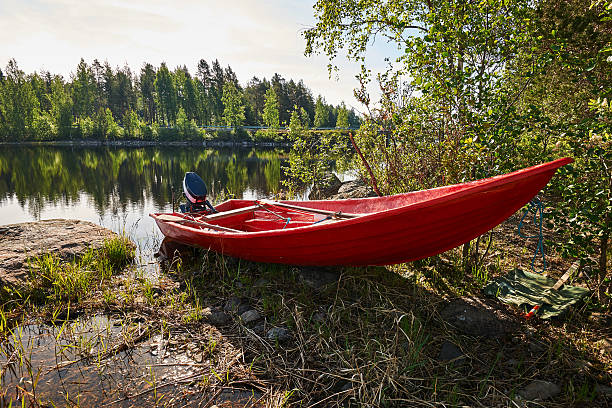 istock Red boat on the lake shore 476502288