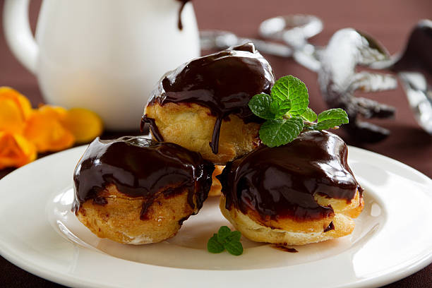 istock profiteroles with cream and chocolate sauce. 476503031