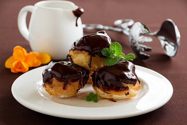 istock profiteroles with cream and chocolate sauce. 476503043