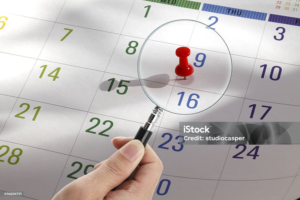 Magnifying glass on a calendar A magnifying glass on the  calendar page. Blue Stock Photo