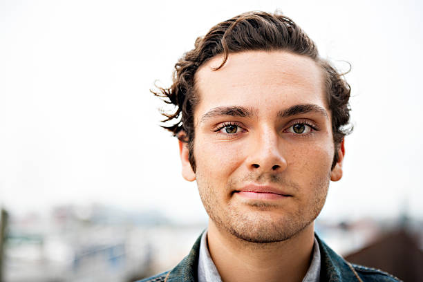 istock Young Man Looks at Camera With Crooked Smile 476505771