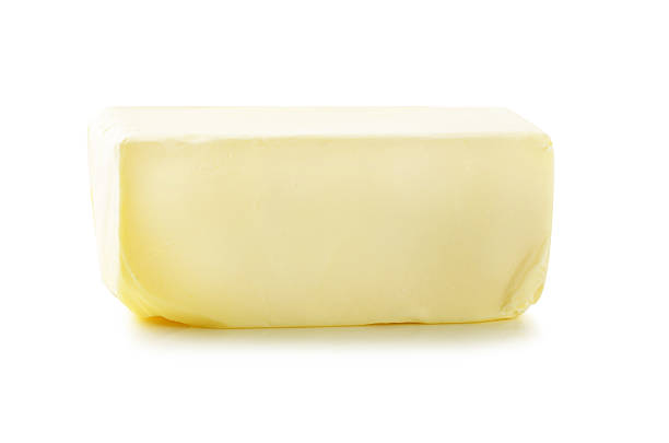 istock Stick of butter, cut, isolated on white. 476509458