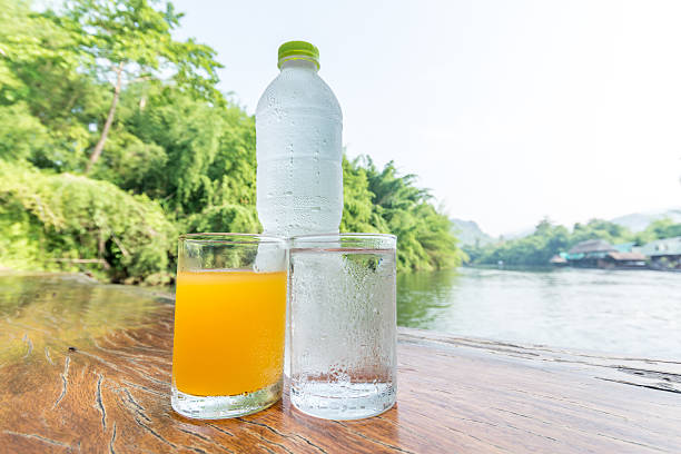 istock Orange juice glass and cold water 476509572
