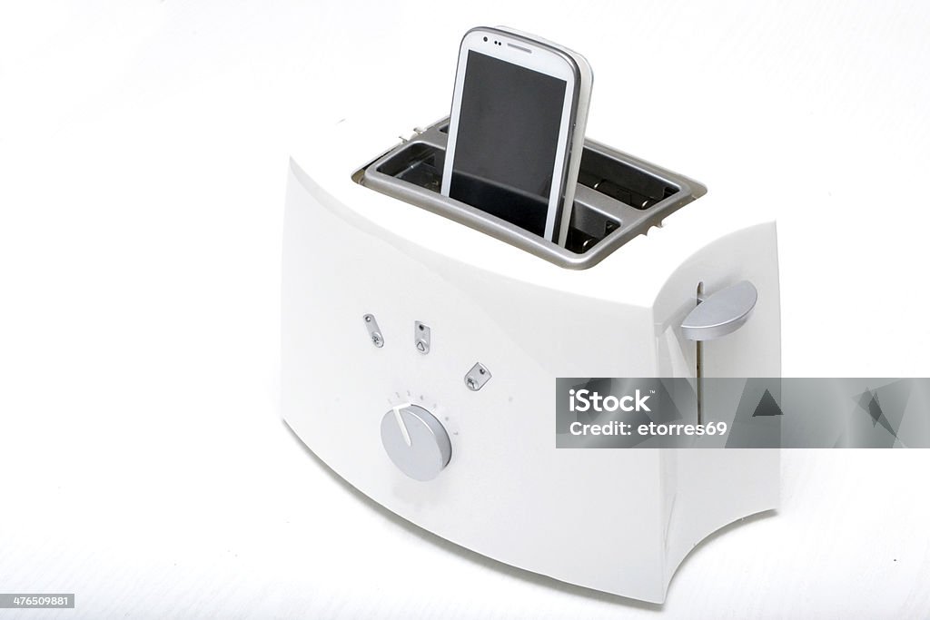 mobile phone in the toaster Bread Stock Photo