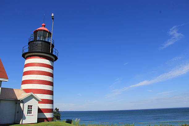 Quoddy Head Lighthouse West Quoddy Head in Lubec, Maine, is the easternmost point of the contiguous United States and the closest point to Europe from a point in the fifty States. West Quoddy Head overlooks Quoddy Narrows, a strait between Canada and the United States. quoddy head state park stock pictures, royalty-free photos & images