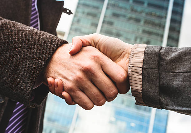 istock Business handshake on the financial district 476516381