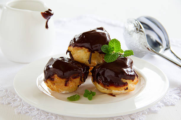 istock profiteroles with cream and chocolate sauce. 476517913