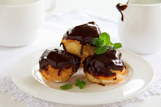 istock profiteroles with cream and chocolate sauce. 476517919
