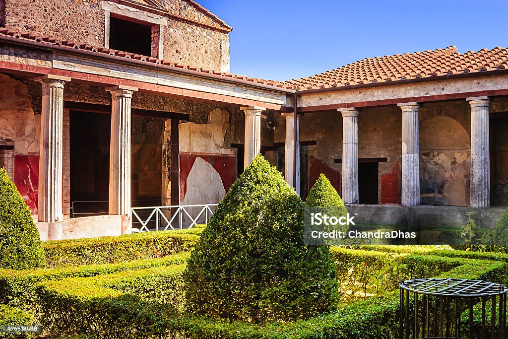 Pompeii, Italy - A Large, Ruined, Luxury Villa Now Reconstructed To Give Visitors An Idea Of What It May Have Looked Like Before The Last Great Volcanic Eruption Of Mount Vesuvius In 79 AD. A Villa in Pompeii, Italy.  The whole city was completely destroyed by the last great erruption of Mount Vesuvius in 79 AD. This elegant villa gives visitors an idea of how the people of Pompeii lived almost 2000 years ago.  Photo shot in the afternoon sunlight; horizontal format.  Copy space. No poeple. Villa Stock Photo