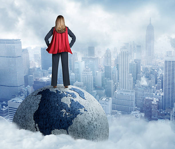 istock Superhero Businesswoman Standing On Globe 476518508