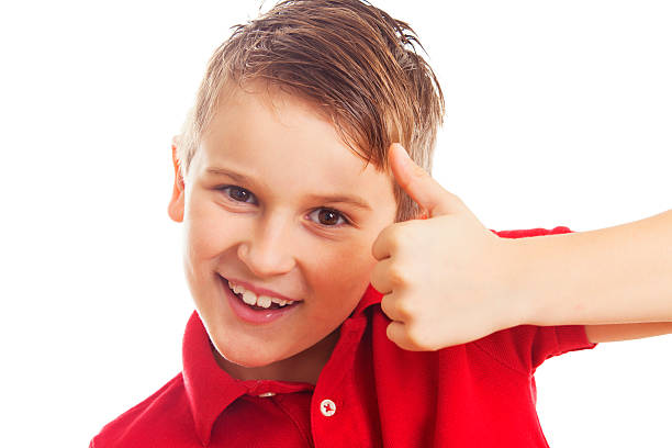istock Thumbs up - happy boy isolated on white 476519171