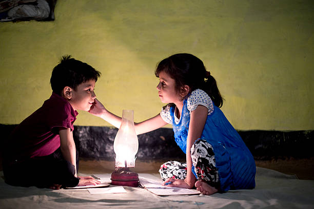 istock Rural girl and boy studying in lantern 476519328