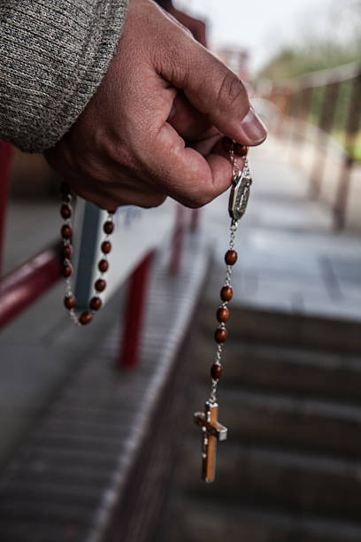 istock Holding a crucifix and rosary beads 476519356