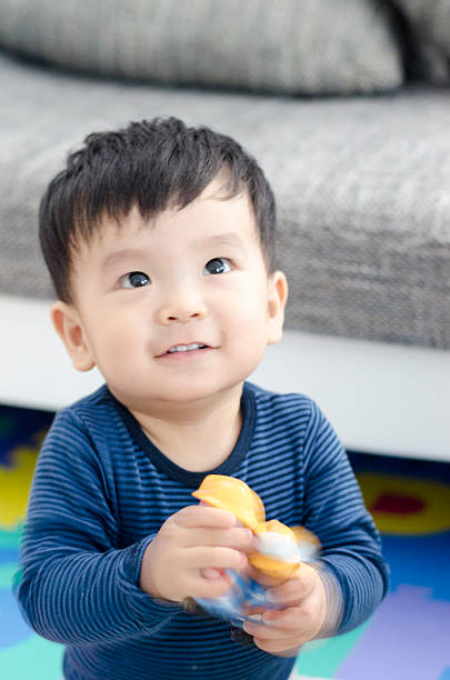 istock Asian Baby Boy playing with Toy 476519360