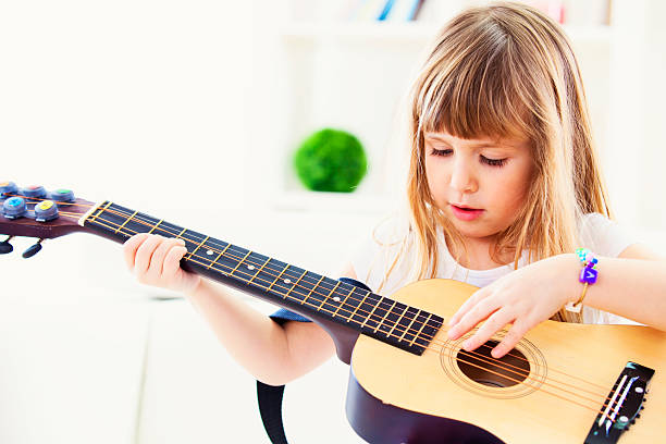 istock Cute girl playing guitar 476521875