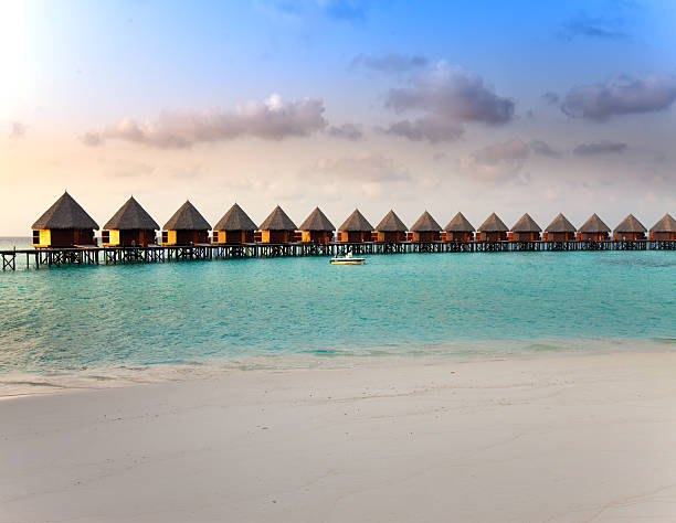 istock Villa on piles in water at the time sunset. 476522898