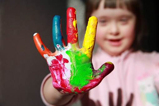 Cute little girl with painted hand