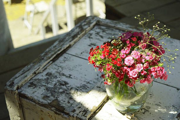 Beautiful flowers in a vase on an old table