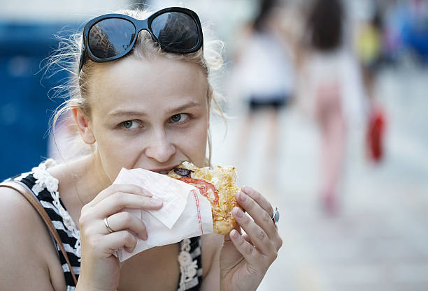 istock Young woman eating 476526225