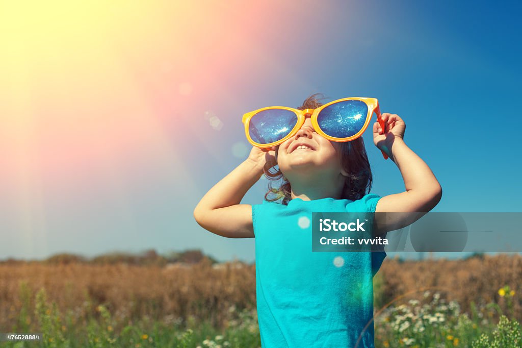 Little girl with big sunglasses enjoys sun Child Stock Photo