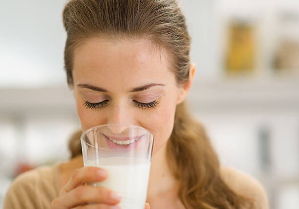 istock Young woman drinking milk in kitchen 476533771