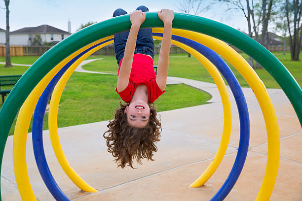 istock children kid girl upside down on a park ring 476536157
