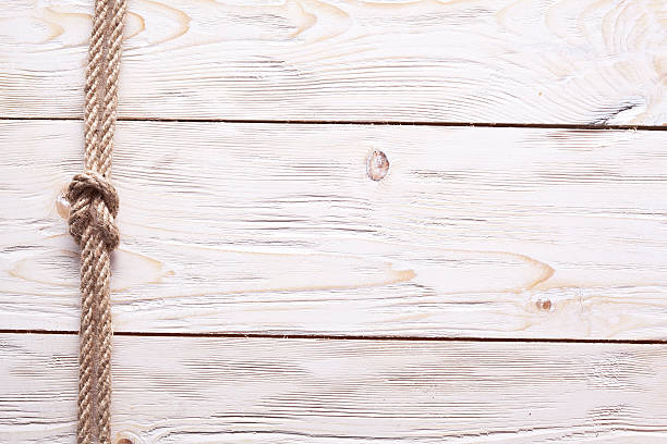 istock Sailor's knot over old wooden background. 476536907