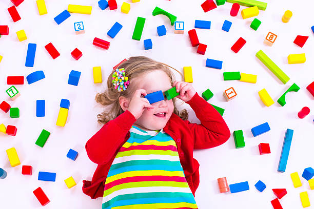 istock Little girl playing with wooden blocks 476538064