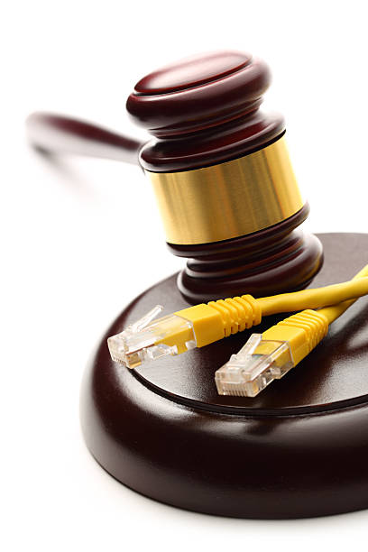 istock Yellow ethernet cable and wooden gavel 476540183