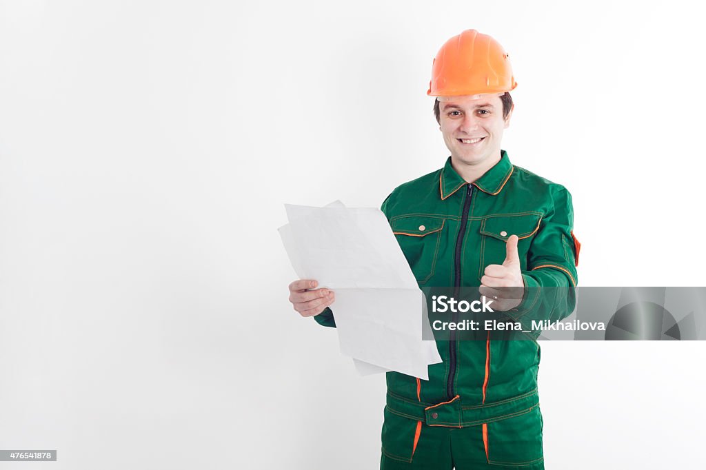 Construction worker with blueprint in one hand and thumb up Builder with blueprint in one hand and thumb of the other hand on the white background 2015 Stock Photo
