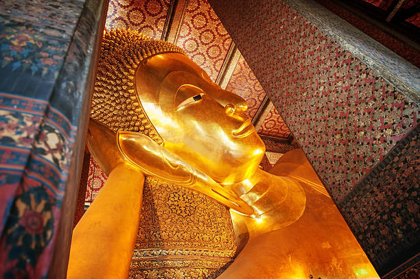 istock Reclining Buddha gold statue face. Wat Pho, Bangkok, Thailand 476545664