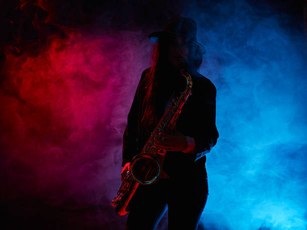 istock Beautiful young woman plays saxophone 476545910