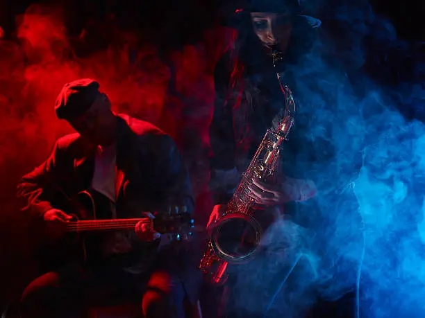 Saxophonist, beautiful young woman, smoky stage and guitarist on background