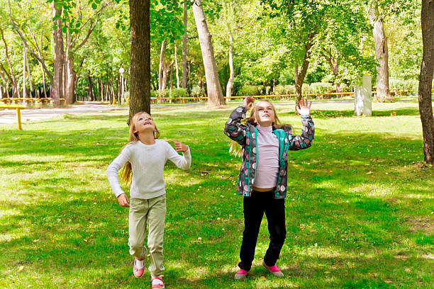 istock Jumping two girls in summer 476547450