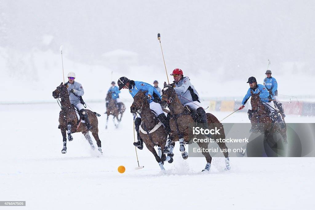 Snow Polo Action St. Moritz, Switzerland - February 2, 2014:  Team BMW's player #4, John-Paul Clarkin, is put under pressure by team Deutsche Bank's player #4, Glen Gilmore, in the bronze final of the 2014 St. Moritz Polo World Cup on Snow. The St. Moritz Polo World Cup on Snow is the world’s most prestigious winter polo tournament. Four high-goal teams with handicaps between 15 and 18 goals battle for the coveted Trophy on the frozen surface of Lake St. Moritz. St Moritz Stock Photo