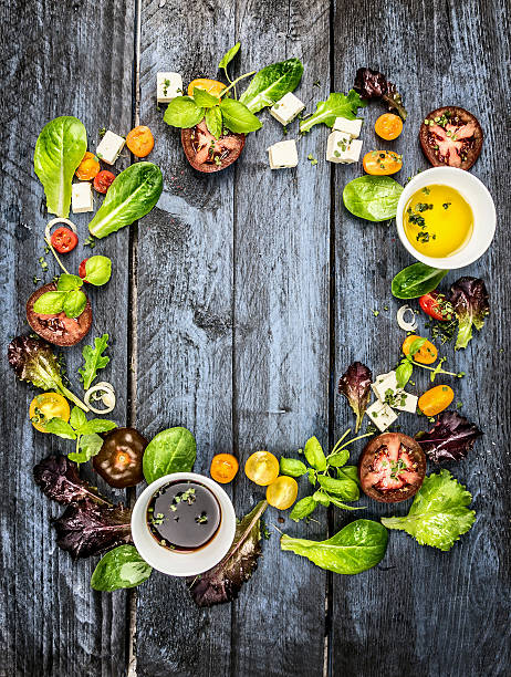 Colorful salad ingredients with tomatoes and feta on rustic background