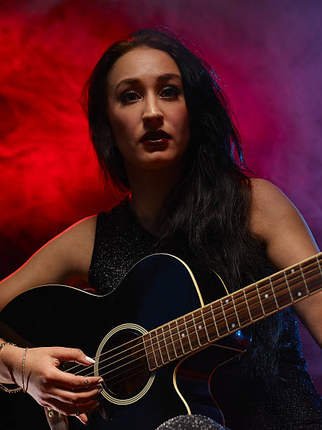 istock Guitarist woman 476548826