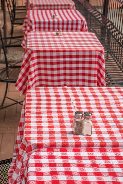 istock Red and White Table Cloths on Square Tables Outdoors 476549266