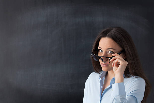 business frau vor einer tafel - teacher thinking business looking up stock-fotos und bilder