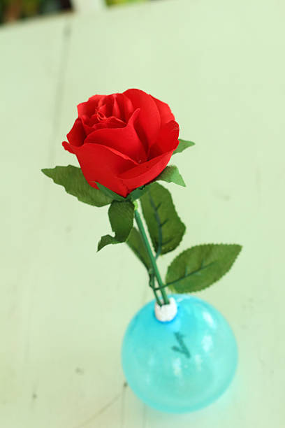 istock Vase of red flowers on a table 476553672