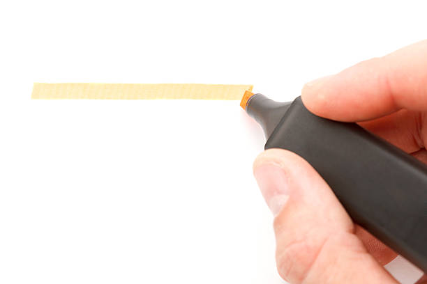 istock Orange highlighter in hand on w white background. 476554474