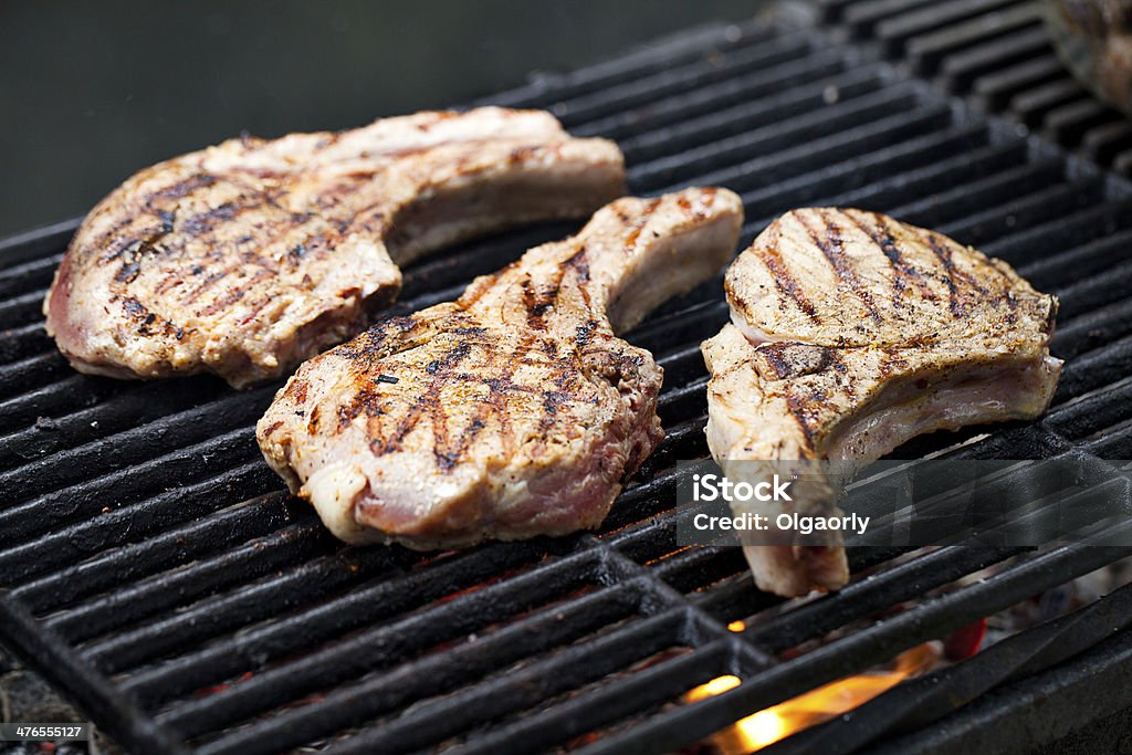 Pork chops on grill Barbecue - Meal Stock Photo