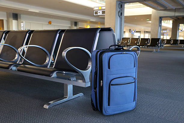 istock Blue suitcase at airport gate. 476555514